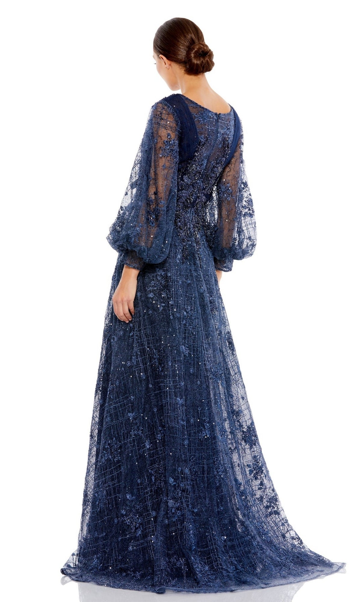 A woman faces away from the camera, wearing the Long Formal Dress 20283 by Mac Duggal—a navy blue gown featuring sheer puff sleeves and intricate embroidery.